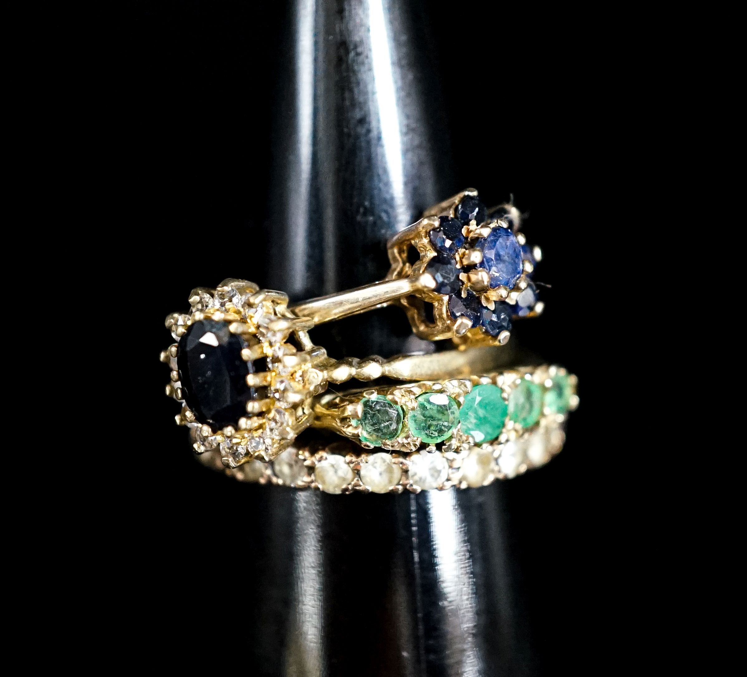 A 9ct eternity ring and three silver gilt rings.